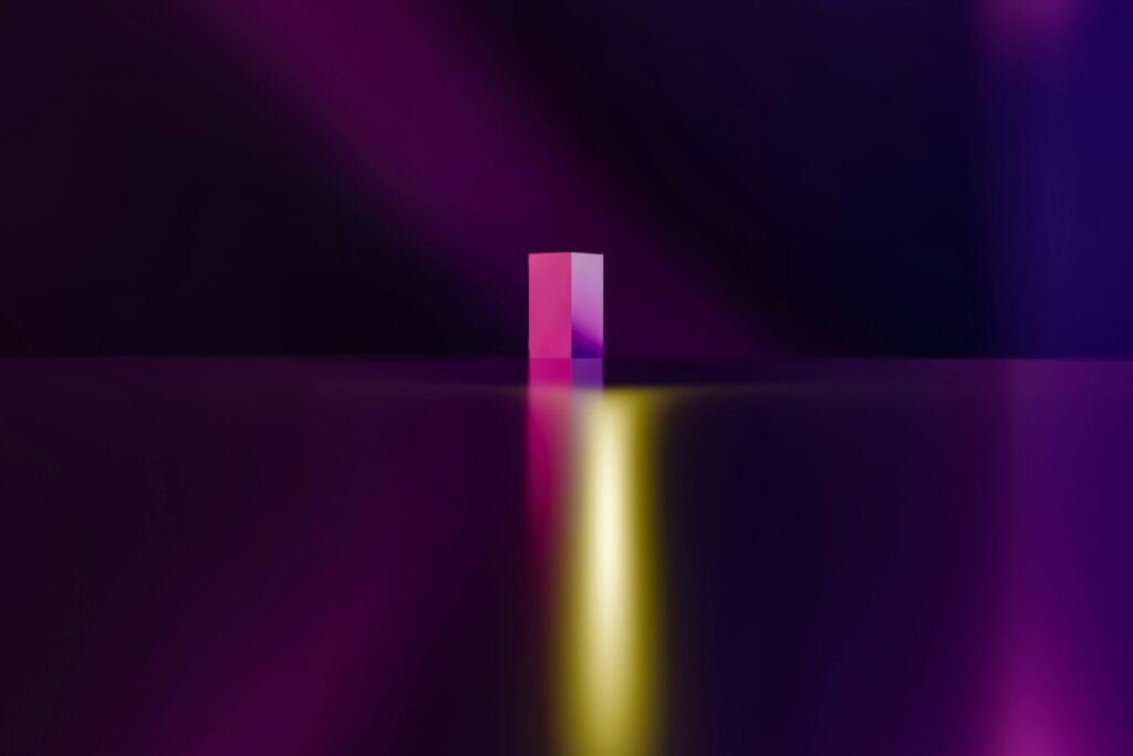 A vibrant geometric artwork showcasing a cube with gradient colors and abstract lighting.