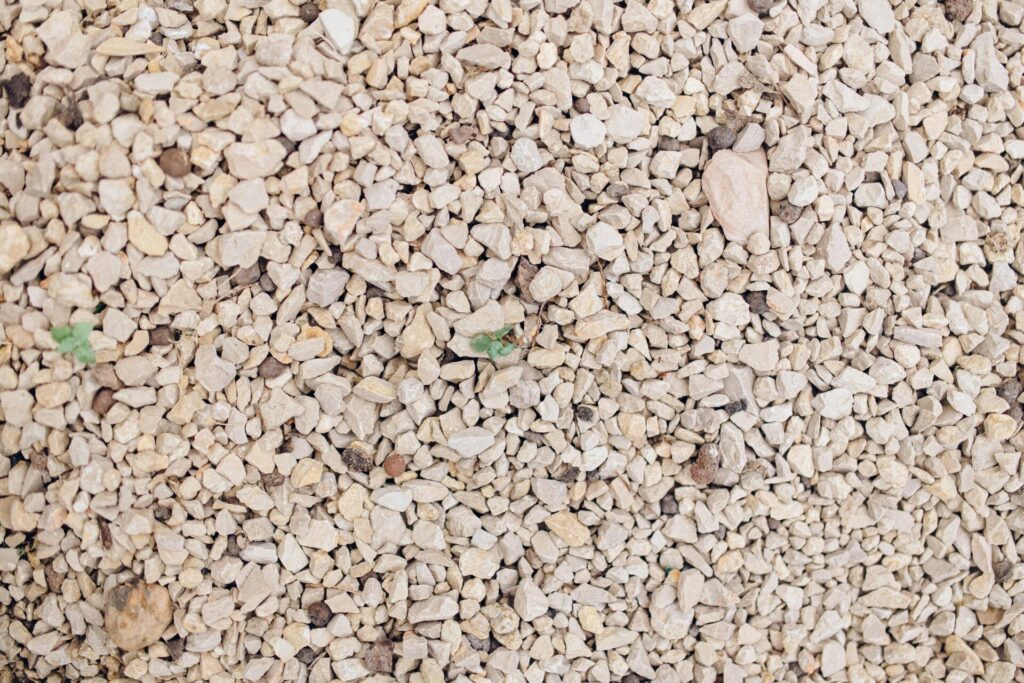 Detailed overhead view of textured stone gravel, ideal for backgrounds and design.