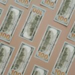 Patterned display of 100 US dollar bills, showcasing wealth and finance themes.