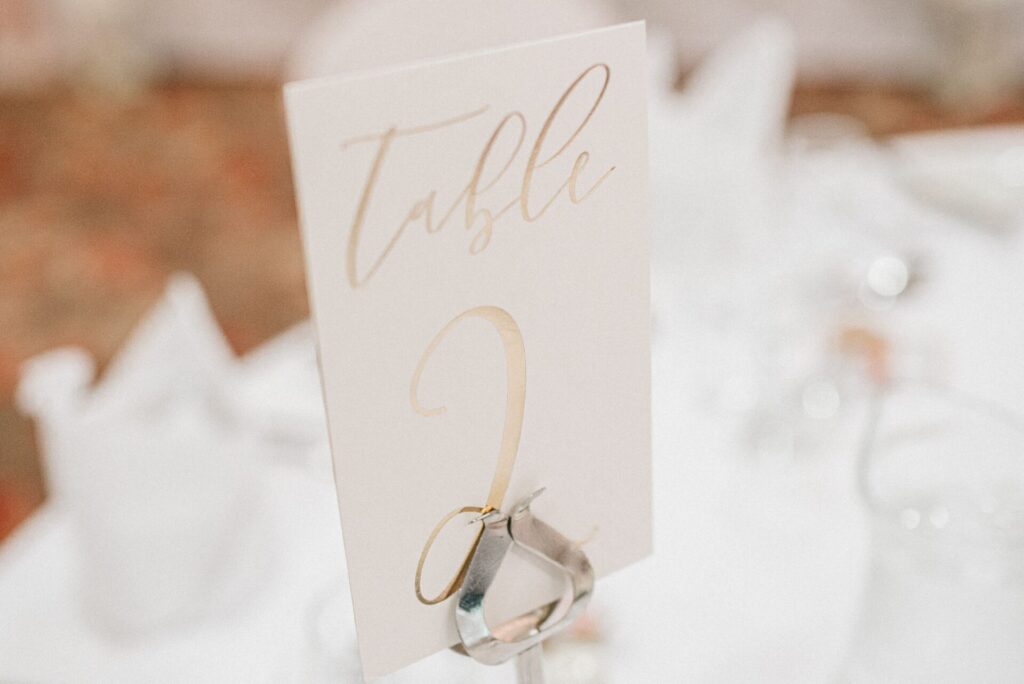 A stylish table number card elegantly displayed at a wedding reception, highlighting sophistication and decor.