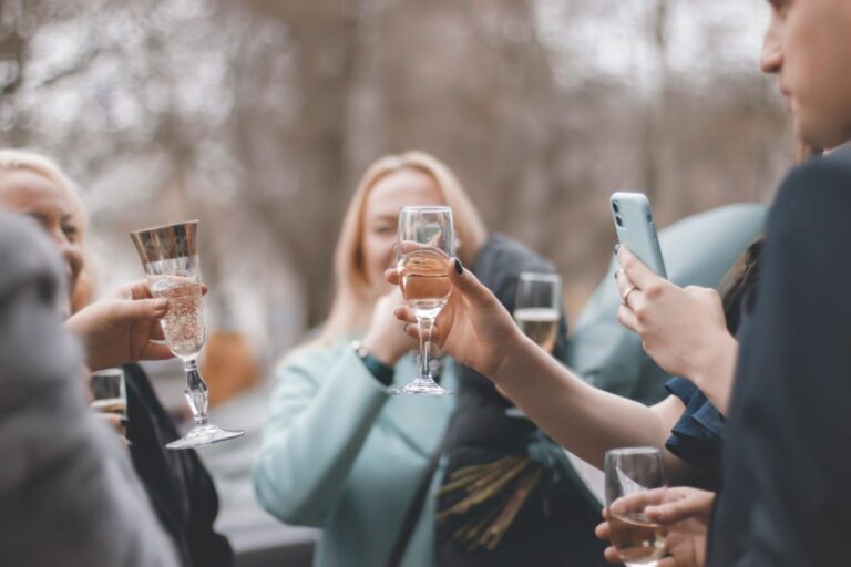 A group of friends toasting with champagne outdoors, capturing a moment of joy and celebration.