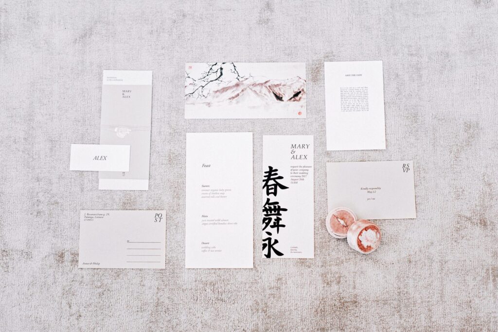Elegant flat lay of wedding invitations with calligraphy and floral accents.